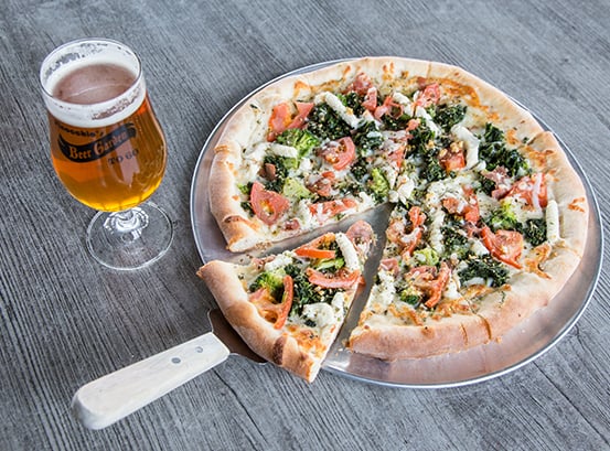 Personal pizza and a glass of beer.